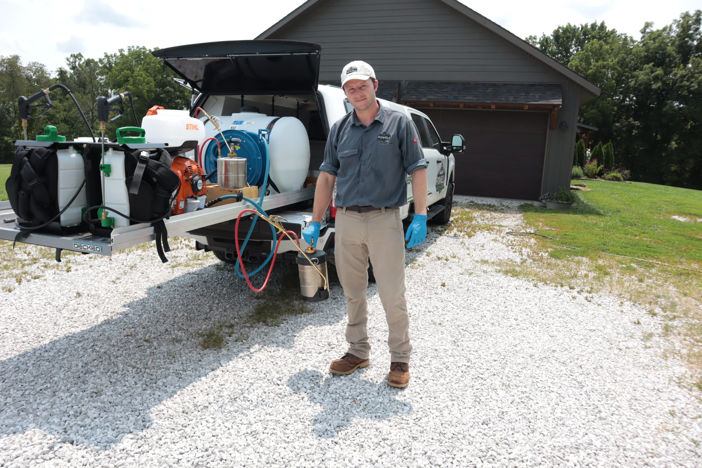 Cooper Powell with pest treatment equipment Cooper Powell beside the Powell Pest and Lawn service truck and treatment equipment