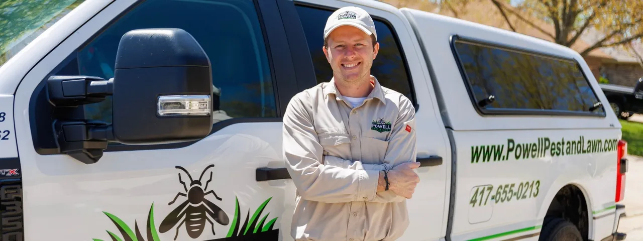 Cooper Powell of Powell Pest and Lawn posing in front of work truck